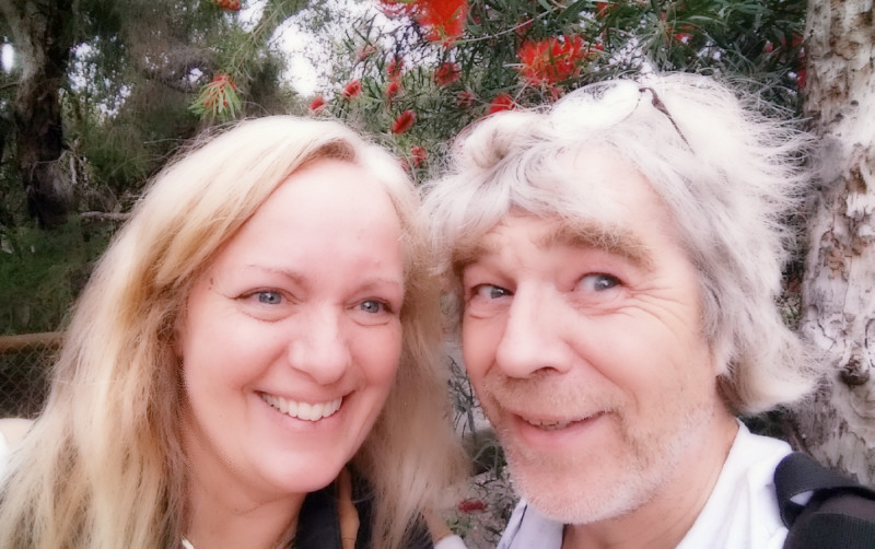 You think John could be serious for 2 seconds so I could get a photo of us in front of a tree with red flowers for my mom?