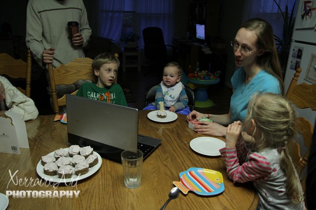 The family gathers along with Nana Sandy and Grandpa Keith on the laptop.