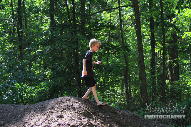 Laura announced it was time to leave the playground area and go to the lake. Silas climbed a mountain on his way there.