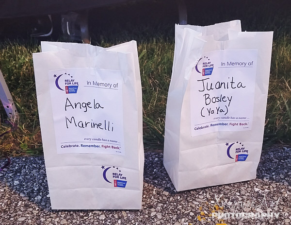 Chris buys memorials for the luminaria ceremony in honor of her friend Angie, and added another one to the one CVS had for mom.