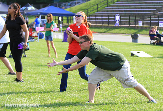 Stacey stretches to get the balloon.
