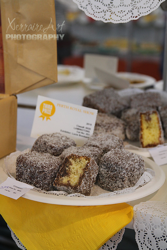 An Australian favorite, Lamington. A lamington is a dessert of Australian origin. It consists of squares or more often these days rectangles of sponge cake coated first in a layer of traditionally chocolate sauce, then in desiccated coconut. Lamingtons are sometimes served as two halves with a layer of cream or strawberry jam between