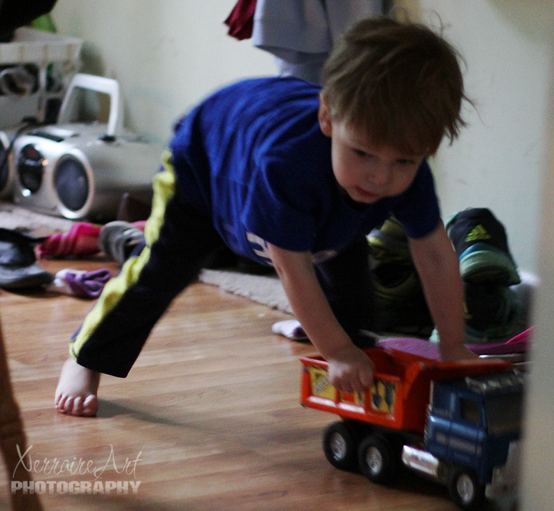 She watches me play with my trucks, in spite of the loud noises it makes.