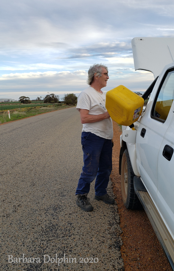 John putting gas in the truck