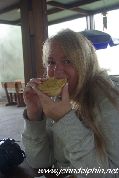 John gets a photo of me trying the meat pie
