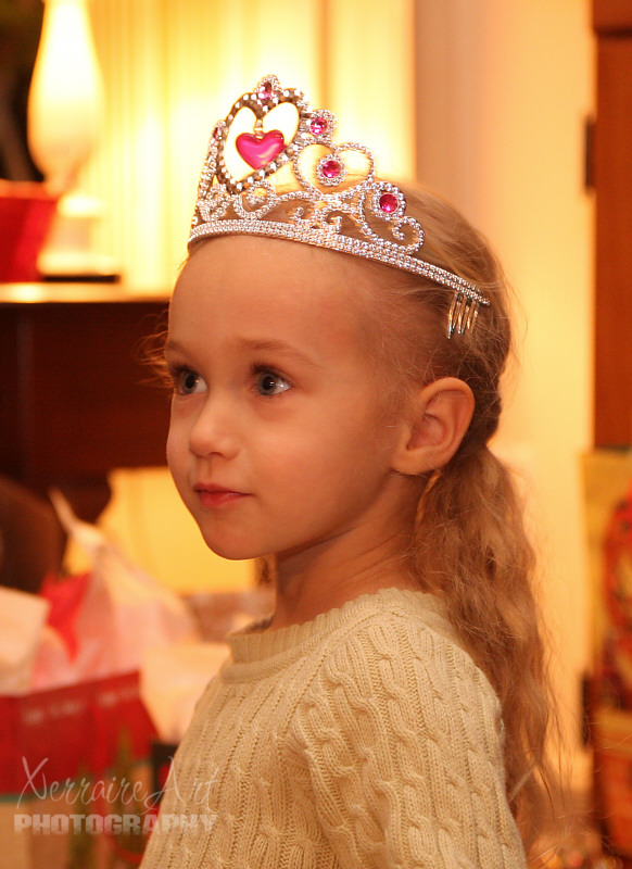 Trying on her crown.