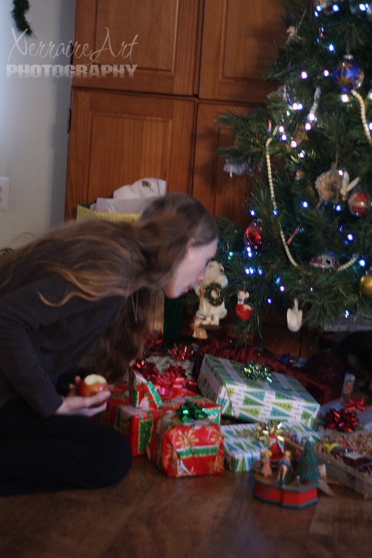 Caught! Their mama the biggest kid of all at Christmas, disguised as a good lady eating an apple, sneaking a peak at the Christmas presents! :)