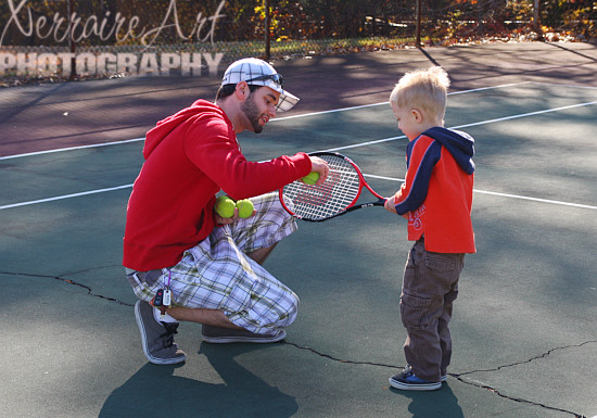 Miquel shows Silas how the racket has to face and where the ball needs to be.