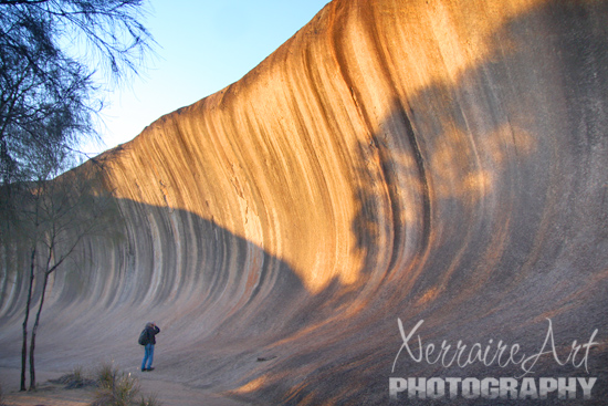 Back down from the top again, I took photos of Wave Rock in the morning light. John is there and shows how tall the rock is.