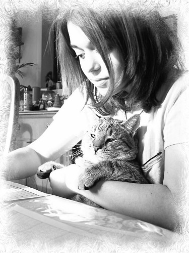 Laura doing schoolwork holding her cat