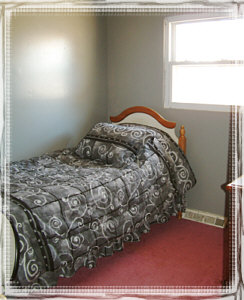 bed and new bedcovers with grey wall
