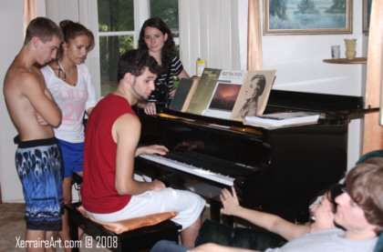 Miquel at the piano, Lauren helping