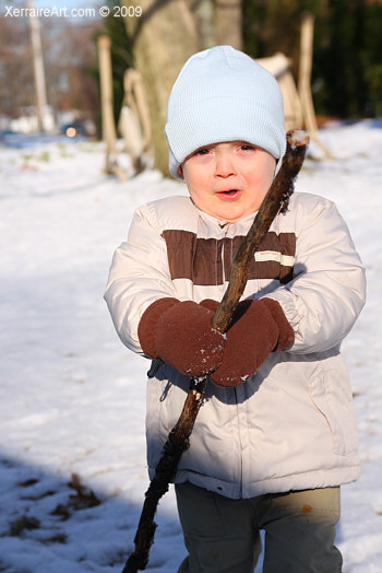 cameron in the snow with a stick