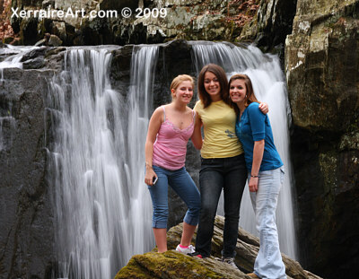 The girls pose in front of the falls