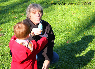 John helping Aiden wth the bubbles